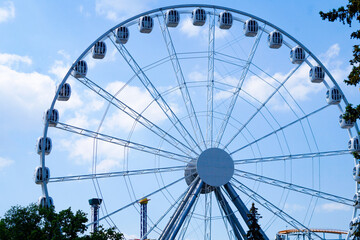 Ferris wheel in an amusement park.Against the blue sky.