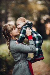 Beautiful caucasian mother with braid embracing her daughter.