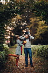 Fototapeta premium Beautiful and happy family with little child in park.