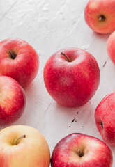 Fresh red apples on a white wooden background. Side view.