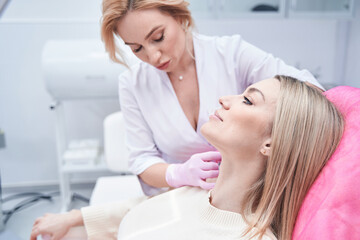 Experienced female doctor carrying out mesotherapy procedure