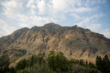 Fototapeta premium Morning LIght Begins to Hit Rising Wolf Mountain In Glacier