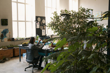 Professional florist working in the big workshop