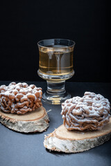 Traditional Finnish cuisine: Funnel cakes with powdered sugar topping are eaten around May 1st with homemade Sima (mead)