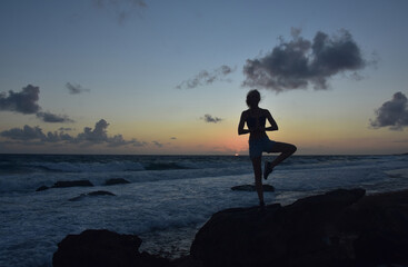 Yoga Tree Pose Silhouetted at Sunrise in Aruba