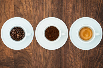 Set of three cup of black coffee. Coffee beans, ground coffee, espresso