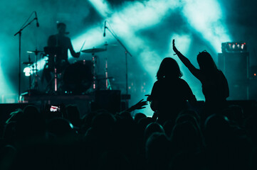 Two woman in the crowd at a music festival