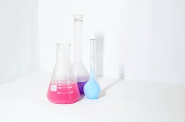 Glassware with colored liquid on the white background