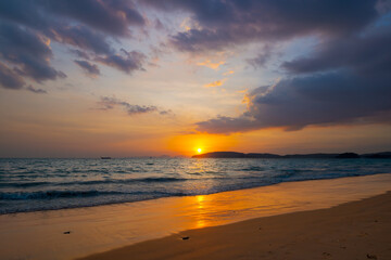 Fototapeta na wymiar Sunset over the tropical sea and beautiful dramatic clouds.