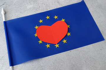 Flag of Europe with red heart symbol, european union flag on gray background, Europe Day 5th and...