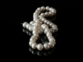 beautiful natural pearls necklace on black background, pawnshop concept, jewerly shop
