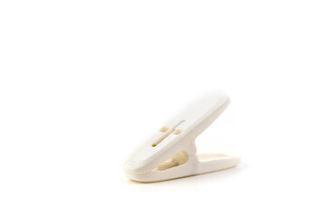 White plastic clothespin on white background