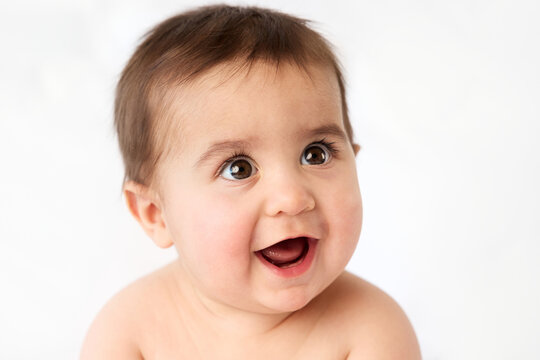 Close-up portrait of smiling baby with open mouth