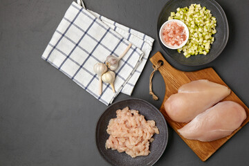 Chopped minced chicken breast fillet of poultry on a cutting board and in a bowl, chopped zucchini