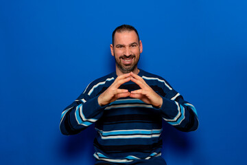 Cunning bearded man clasping hands and planning evil tricky prank or scheming, cheating with sly...