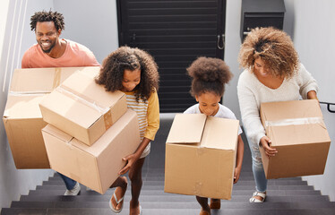 Theres nothing more important than a good, safe, secure home. Shot of a family carrying boxes into...