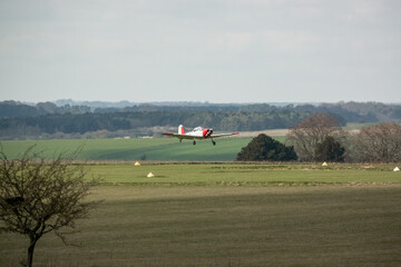 a 1951 De Havilland DHC-1 Chipmunk WD363 22 C-N C1-0304 taking off from a grass runway