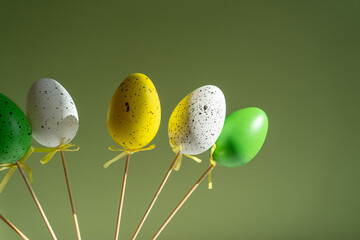 Easter decorations Easter eggs on a light green background with a shadow from the sun in a vase...