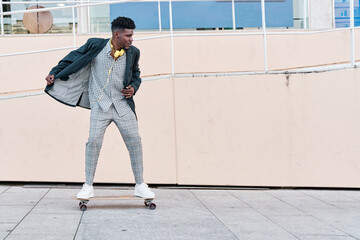 young businessman riding a skateboard in a suit