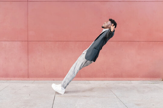 african-american man falling backwards onto concrete floor