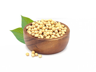 soybean seeds in wooden bowl with green leaves isolated on white background