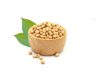 soybean seeds in wooden bowl with green leaves isolated on white background