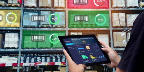 Smart Augmented Reality,AR warehouse management system.Worker hands holding tablet on blurred warehouse as background