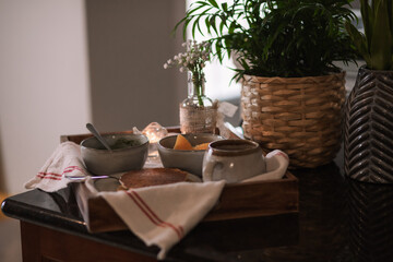 A cozy breakfast setup with green dip, pancake and coffee 