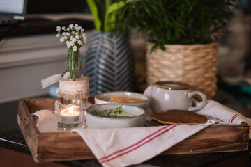 A cozy breakfast setup with green dip, pancake and coffee 