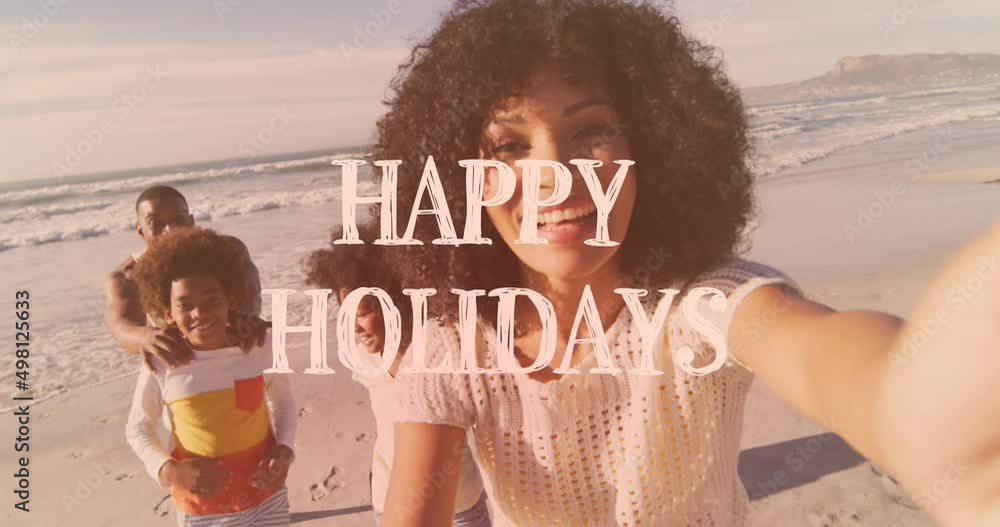 Sticker Animation of happy holidays text over african american family on the beach