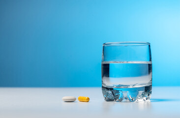 Glass of water and pills