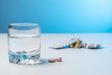 Glass of water and pills