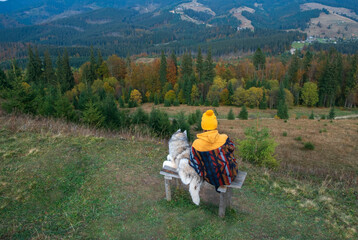 Girl resting with her siberian husky dog together outdoor. Human and animal friendship concept
