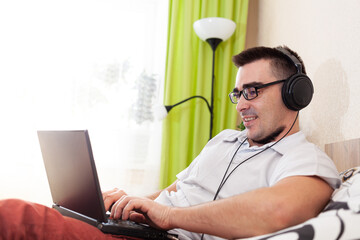 A man works on a computer remotely from home