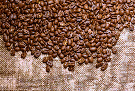 Roasted coffee beans with burlap background