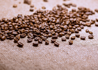 Roasted coffee beans with burlap background