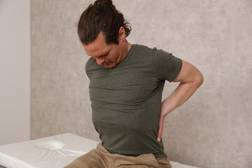 Man suffering from lower back pain. Chiropractic concept. Sport exercising injury