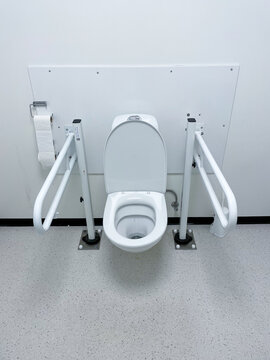 View Of A Disabled Toilet In A Pubic Bathroom, With Handels 