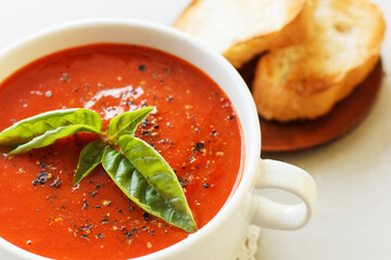Italian tomato soup with basil, spices and croutons. Close-up.
