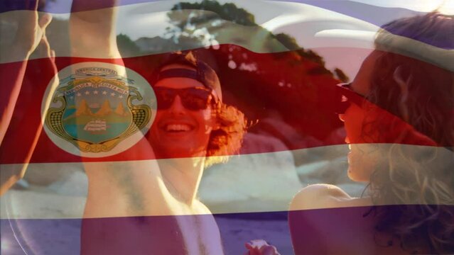Animation of waving costa rica flag over group of friend on the beach