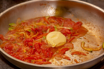 Cook preparing tomato sauce with pepper for pasta