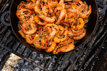 crispy fresh shrimp cooked on a frying pan in the wild. Rest in nature with fresh food
