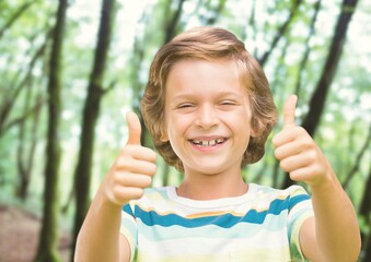 Composite image of portrait of caucasian boy with thumbs up smiling against tall trees in background