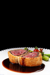 Beef Wellington with chanterelles, asparagus and black truffle with spicy Razmarin sauce