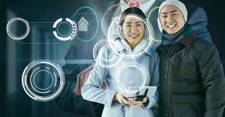 Multiple round scanners over portrait of asian couple smiling against businessman using smartphone