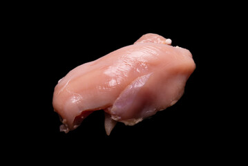Raw chicken fillet isolated on a black background.