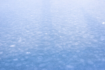 Fototapeta na wymiar Natural texture of ice, frozen lake as background.