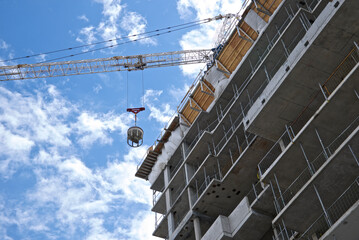 Crane - machinery in action in the construction site.