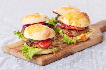 four small hamburges on a board