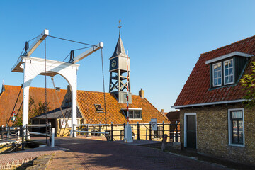 Drawbridge and clock tower at the lock in the picturesque town of Hindeloopen in Friesland.